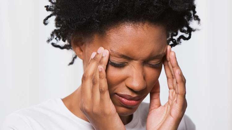 Young woman stressed rubbing temples